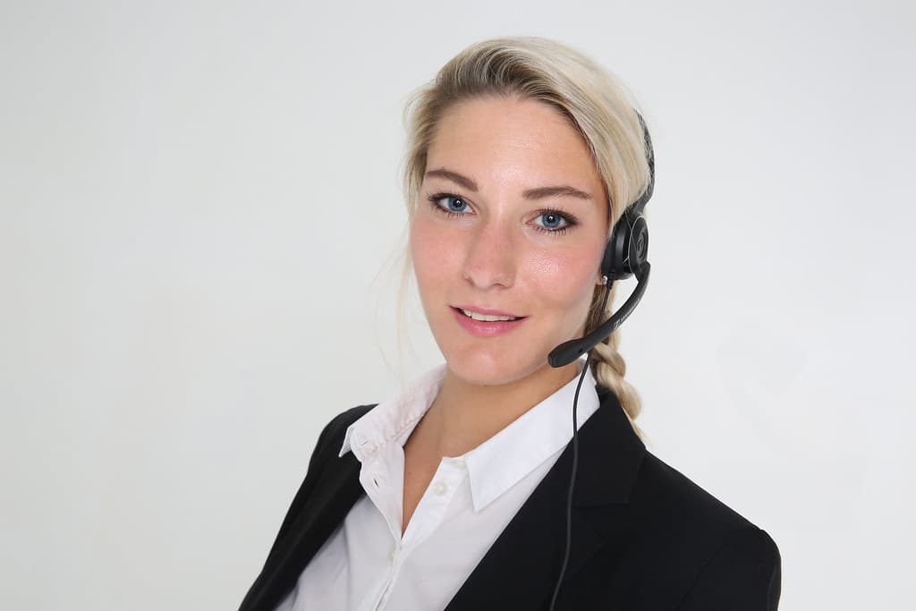 Support agent wearing a headset at a workstation