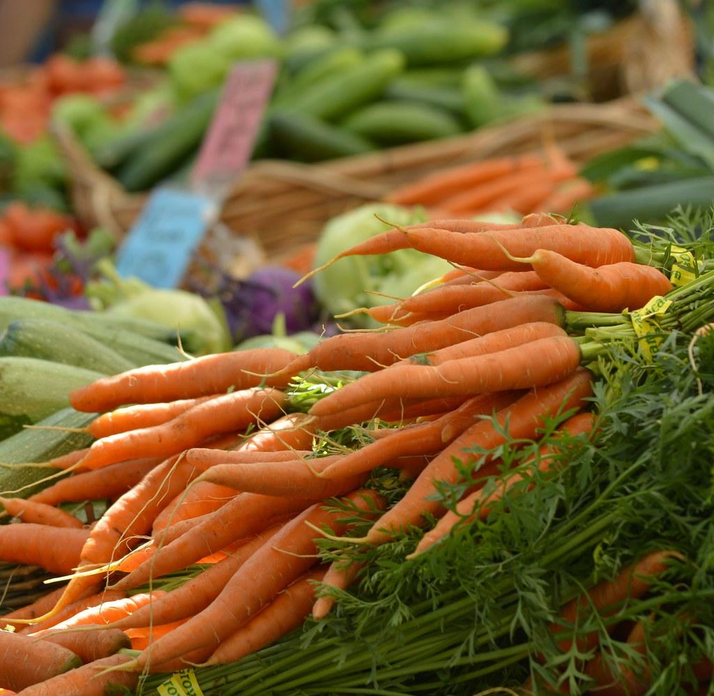 Fresh produce stalls at a busy open-air market